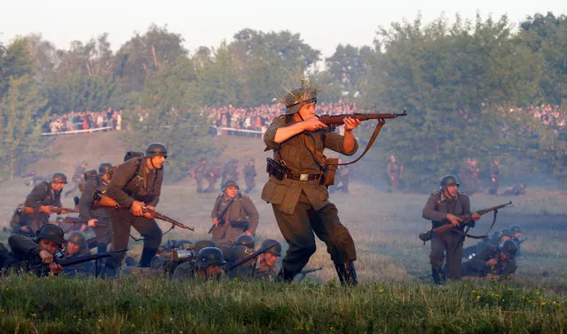 Military enthusiasts dressed as Nazi troops take part in a re-enactment of a World War II battle at the Hero fortress as they mark the 75th anniversary of the Nazi Germany invasion, in Brest, Belarus June 22, 2016. (Photo by Vasily Fedosenko/Reuters)