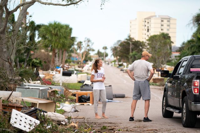 Residents talk to a motorist on a street littered with storm debris from Hurricane Helene and Hurricane Milton in the aftermath of Hurricane Milton on October 10, 2024 in Venice, Florida. Hurricane Milton made landfall as a Category 3 hurricane in the Siesta Key area. (Photo by Sean Rayford/Getty Images) (Photo by Sean Rayford/Getty Images)