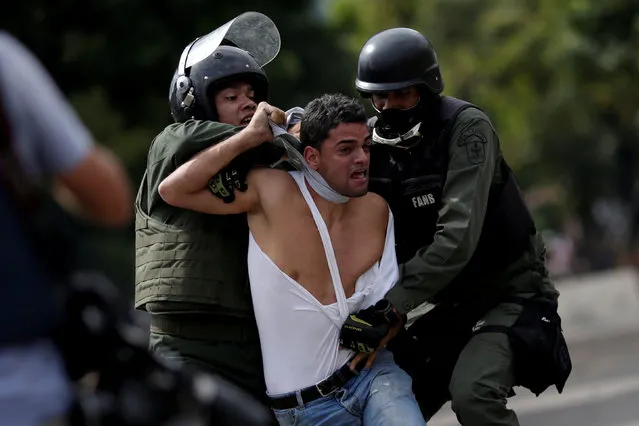 A demonstrator is detained at a rally during a strike called to protest against Venezuelan President Nicolas Maduro's government in Caracas, Venezuela, July 27, 2017. (Photo by Ueslei Marcelino/Reuters)