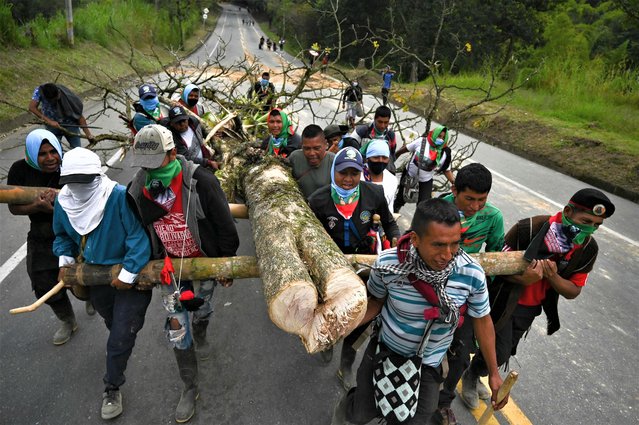 Indigenous people hold a demonstration blocking the Pan-American highway to protest against the Colombian government and demanding land rights in the region and better health and education conditions in Piendamo municipality, Cauca department, Colombia, on August 1, 2023. (Photo by Joaquin Sarmiento/AFP Photo)