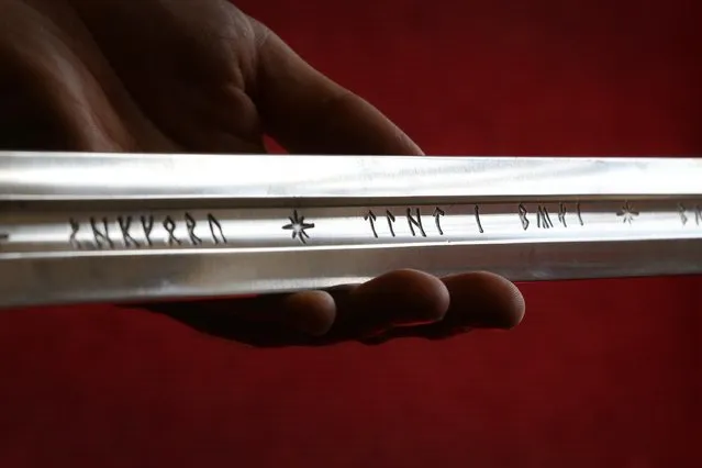 Elvish writing is seen on “Anduril”, a prop sword belonging to Aragorn, hero of “The Lord of the Rings” movie trilogy on July 31, 2014 in London, England. The sword, belonging to actor Sir Christopher Lee and estimated at $150,000-250,000, forms part of Bonhams “There's No Place Like Hollywood” movie memorabilia auction taking place in New York on November 24, 2014. (Photo by Peter Macdiarmid/Getty Images)