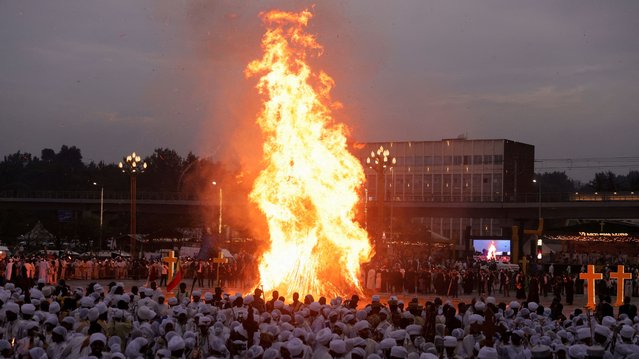 Ethiopian Orthodox faithful stand next to a bonfire during the Meskel festival, a celebration that commemorates the discovery of the True Cross on which Jesus Christ was crucified, in Addis Ababa, Ethiopia, on September 26, 2024. (Photo by Tiksa Negeri/Reuters)