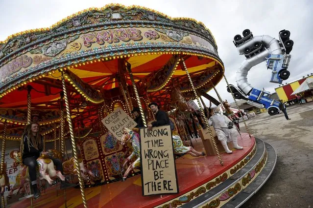 People ride a carousel at “Dismaland”, a theme park-styled art installation by British artist Banksy, at Weston-Super-Mare in southwest England, Britain, August 20, 2015. (Photo by Toby Melville/Reuters)