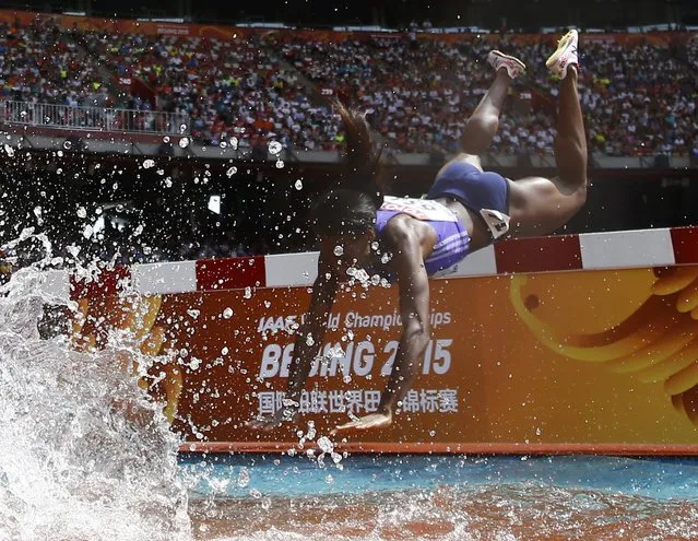 Rolanda Bell of Panama falling head first into the water obstacle during the women's 3000 metres steeplechase heats at the 15th IAAF World Championships in the National Stadium in Beijing, China August 24, 2015. (Photo by Kai Pfaffenbach/Reuters)