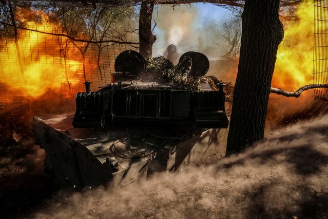 Ukrainian servicemen of the 10th separate mountain assault brigade “Edelveis” of the Armed Forces of Ukraine fire a 2S1 Gvozdika self propelled howitzer towards Russian troops, amid Russia's attack on Ukraine, at a position in the Donetsk region, Ukraine on September 26, 2023. (Photo by Oleksandr Ratushniak/Reuters)