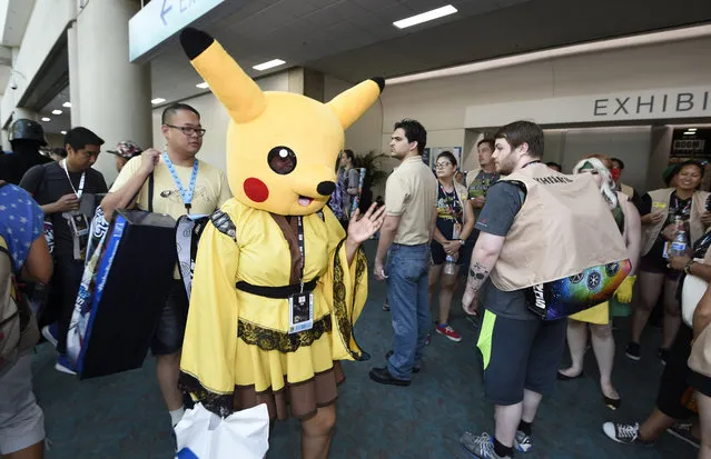 Denise Zesati, dressed as a Pokemon Pikachu, waves to fans on day two of Comic-Con International held at the San Diego Convention Center Friday, July 22, 2016 in San Diego. (Photo by Denis Poroy/Invision/AP Photo)