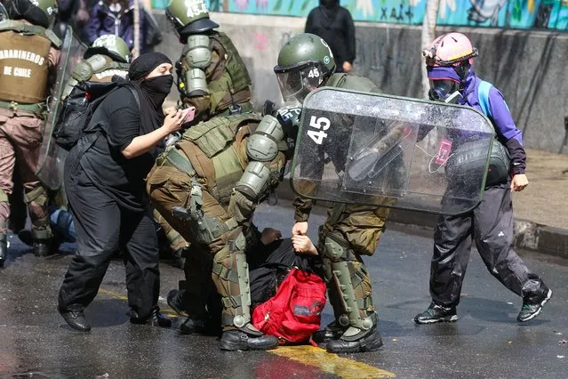 Police detain a demonstrator during a day of protests, in Santiago, Chile, 06 September 2022. Hundreds of students, mostly from secondary schools, demonstrated this 06 September in the great avenue of Santiago, in the surroundings of the Palacio de La Moneda, at the same time that the President of the Republic, Gabriel Boric, was preparing to announce his first big change of government. The march, which began peacefully, ended after noon in clashes with security forces and riot police, who used tear gas and trucks with pressurized water hoses to repress the most violent groups, who threw stones at the authorities. (Photo by Sebastian Nanco/EPA/EFE)