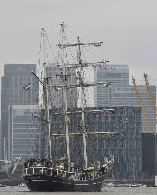 The tall ship Thalassa sails up the River Thames with the Canary Wharf business district seen in the background in London September 7, 2014. Over 50 tall ships from around the world will participate in the Royal Greenwich Tall Ships Regatta 2014 until Tuesday. (Photo by Toby Melville/Reuters)