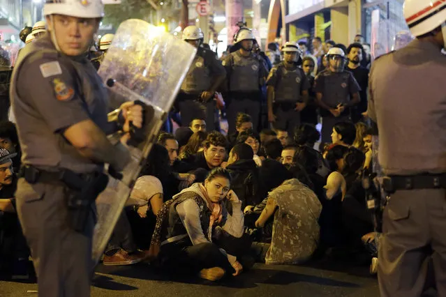 Police officers detained a group of protesters during a march against the money spent on the Rio's 2016 Summer Olympics and the interim Brazilian president Michel Temer in Sao Paulo, Brazil, Friday, August 5, 2016. (Photo by Nelson Antoine/AP Photo)