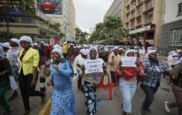 Kenyan women march during a multi-faith demonstration calling for peace outside Supreme Court in downtown Nairobi, Kenya, Wednesday, October 25, 2017. (Photo by Ben Curtis/AP Photo)