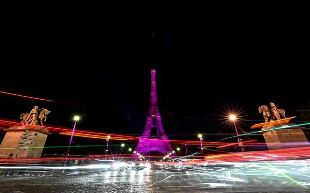 A photo shows the Eiffel Tower illuminated in pink to mark the Breast Cancer Awareness Month, an annual campaign to raise awareness about the impact of breast cancer, in Paris, on October 1, 2022. (Photo by Stefano Rellandini/AFP Photo)