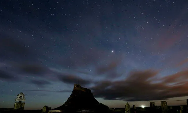 This January 9, 2014, photo shows, a view of the stars above Lindisfarne Castle in Holy Island, England, Thursday, Jan. 9, 2014. Scientists reported Thursday, November 6, 2014, that as many as half of all stars may lie outside galaxies. (Photo by Scott Heppell/AP Photo)