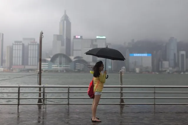 A woman stands on the Victoria Harbour waterfront during typhoon Nida in Hong Kong, China, 02 August 2016. Nida is the first major typhoon to shut down Hong Kong this year. (Photo by Jerome Favre/EPA)