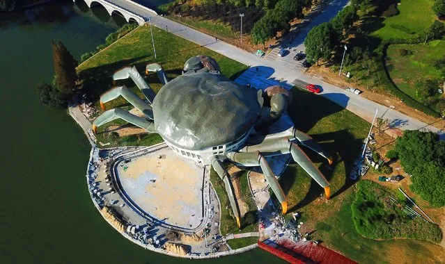Aerial view of a crab-shaped eco museum under construction on the shore of Yangcheng Lake on October 31, 2017 in Suzhou, Jiangsu Province of China. The crabs produced in Yangcheng Lake have long enjoyed great reputation abroad, and are sometimes known as 'Chinese Mitten Crabs'. The stainless steel exo museum is 75 meters long and 16 meters high with three floors in all, which will provide residents a place for recreation and leisure after completion. The construction work is still under way and it is expected to open in the second half of the next year. (Photo by VCG/VCG via Getty Images)