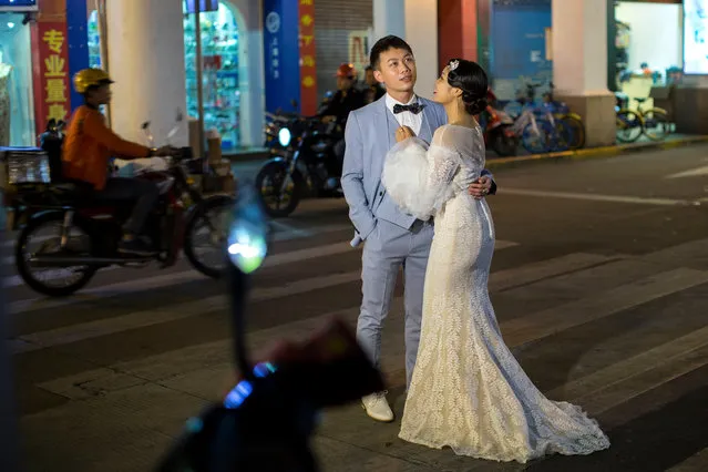 A couple has their wedding photographs taken on a main street in Zhongshan, Guangdong Province, China, 04 November 2017. Zhongshan, a 90-minute ferry ride from Hong Kong, is situated on the western side of the Pearl River Delta, a main waterway that connects Guangzhou with Hong Kong and Macau. (Photo by EPA/EFE/Stringer)
