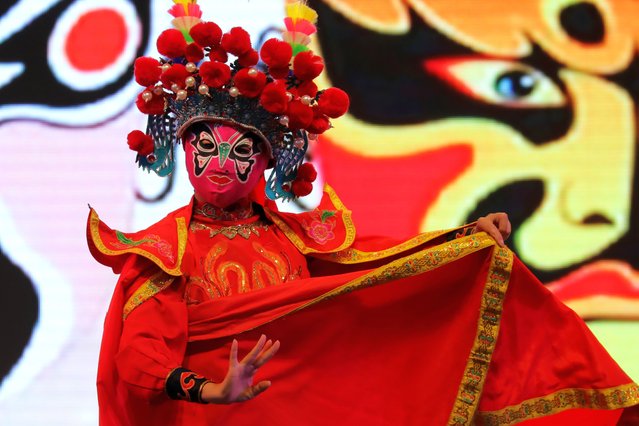 A dancer performs in front of illuminated decorations during the 'International Festival of Chinese Lights' in a park in Santiago, Chile on January 15, 2024. The Chinese Lights Festival “Tianfu Festival” exhibits monumental three-dimensional sculptures with more than a million lights, combining shapes, colors, music and art, made by Chinese artisans that give life to animals, flowers, mythological beings and scenes from oriental culture. (Photo by Lucas Aguayo Araos/Anadolu via Getty Images)