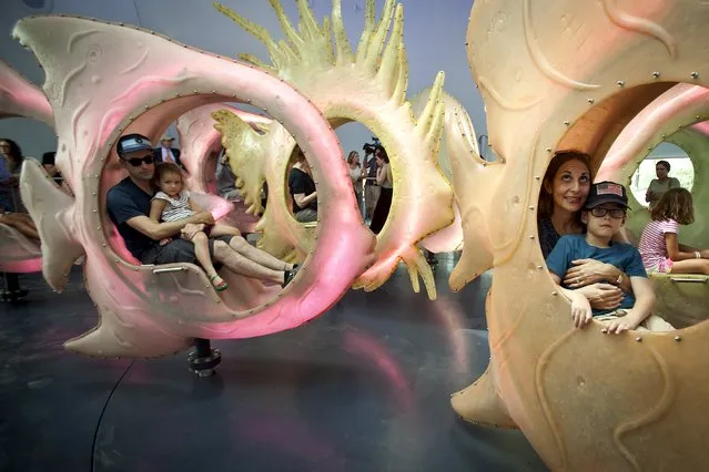 People ride in fish during a media preview of the new “Sea Glass” carousel at Battery Park in the Manhattan borough of New York, August 19, 2015. (Photo by Carlo Allegri/Reuters)