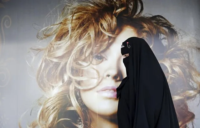 Gisele Marie, a Muslim woman and professional heavy metal musician, walks past a poster after a rehearsal at her house, in Sao Paulo September 15, 2015. (Photo by Nacho Doce/Reuters)