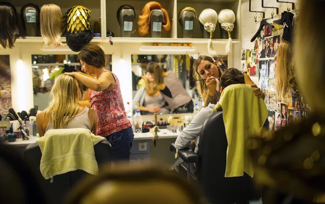 Dancers are made-up prior to a dress rehearsal. (Photo by Hannibal Hanschke/Reuters)