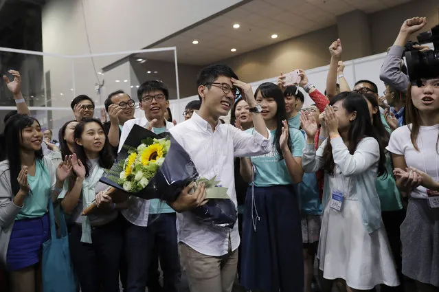 Political party Demosisto's Nathan Law, center, who helped lead the 2014 protests, celebrates with his supporters after winning a seat at the legislative council elections in Hong Kong, Monday, September 5, 2016. A new wave of anti-China activists appeared headed for victory in Hong Kong's most pivotal elections since the handover from Britain in 1997, which could set the stage for a fresh round of political confrontations over Beijing's control of the city. (Photo by Kin Cheung/AP Photo)