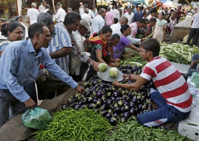 Customers buy vegetables at a market in Ahmedabad, India, September 29, 2015. (Photo by Amit Dave/Reuters)