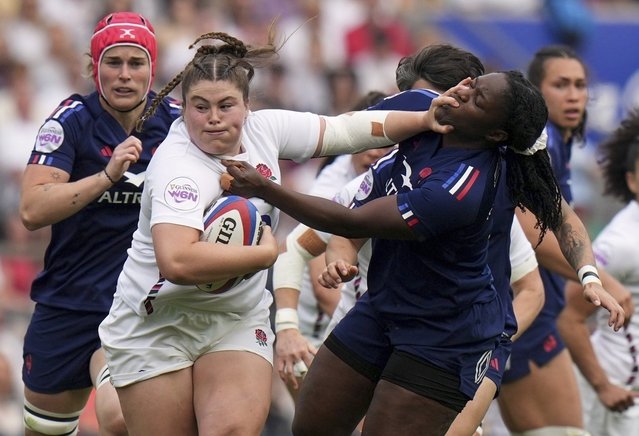 England's Maud Muir, center left, is challenged by Yllana Brosseau, of France, during the Women's Six Nations rugby union match at Twickenham stadium in London, April 26, 2025. (Photo by Alastair Grant/AP Photo)
