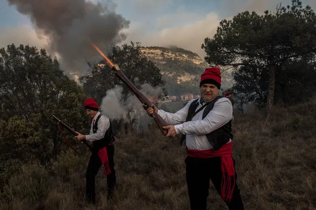 “Galejadors” fire their muskets during “la Festa del Pi” (The Festival of the Pine) on December 30, 2017 in Centelles, Spain. Early in the morning men and women born in Centelles, who are named “Galejadors” wear their traditional costume with the Catalan red hat known as “Barretina” and carry their shooting muskets as they walk into the forest to chop down a pine tree, load it on an ox cart and take it to the church in the village. The pine tree is decorated with five bouquets of apples and wafers and hung inside a church until January 6. The tradition has been documented since 1751 and it is believed its origins are related to the trees and the pagan worship of fertilization related to the winter solstice. (Photo by David Ramos/Getty Images)