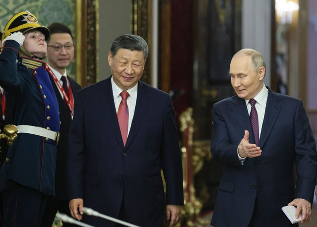 Russian President Vladimir Putin (R) welcomes China's President Xi Jinping (C) prior to their meeting at the Kremlin in Moscow, Russia, 08 May 2025. Russia will mark the 80th anniversary of the victory in World War II over Nazi Germany and its allies on 09 May. (Photo by Yuri Kochetkov/EPA/EFE)