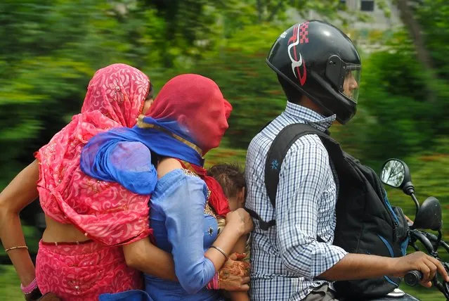 “Family Life”. In my recent studies of the Indian society, it is clear that the traditional Indian family unit is sacred and the roles of the family are well defined. The Grandmother, who has taken a back seat, cannot help but peer ahead as she holds her daughter and grandchild. The daughter has now taken the role of the mother. Photo location: Delhi, NCT, India. (Photo and caption by Philip M. T./National Geographic Photo Contest)