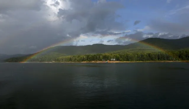 A rainbow is seen above the “Biryusa” international youth camp, located on the bank of the Yenisei River in the Taiga district outside the Siberian city of Krasnoyarsk, Russia, August 3, 2015. (Photo by Ilya Naymushin/Reuters)
