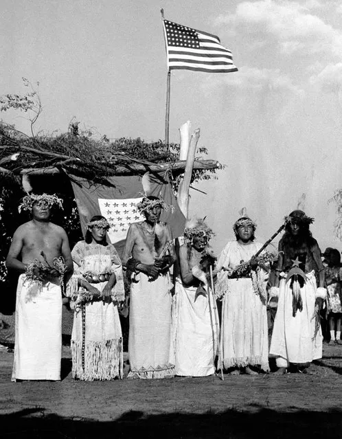  In this August 8, 1942 file photo, members of the Standing Rock Sioux perform an ancient War Dance ceremony to support soldiers of their tribe on duty with the U.S. Army, in Little Eagle, S.D. The service flag behind them shows 22 stars, indicating the number of Little Eagle tribesmen serving . The War Dance ceremony was the first one to be performed in 52 years. (Photo by U.S. Signal Corps via AP Photo)