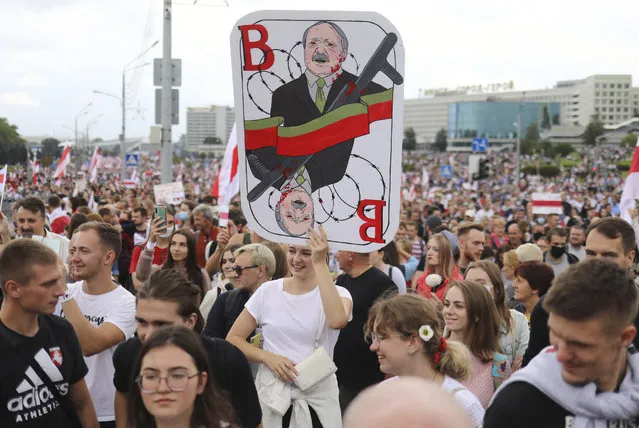 A woman holds a caricature of Belarus President Alexander Lukashenko during an opposition rally to protest the official presidential election results in Minsk, Belarus, Sunday, September 6, 2020. (Photo by TUT.by/AP Photo)