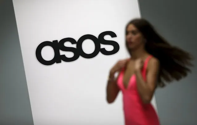 A model walks on an in-house catwalk at the ASOS headquarters in London, Britain in this April 1, 2014 file photo. ASOS is expected to report full year results this week. (Photo by Suzanne Plunkett/Reuters)