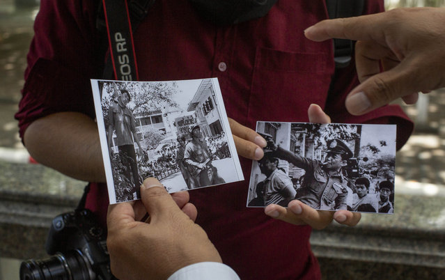 University students explore the past through pictures taken during a student massacre over 40 years ago at the Thammasat University, in Bangkok, Thursday, October 1, 2020. (Photo by Gemunu Amarasinghe/AP Photo)