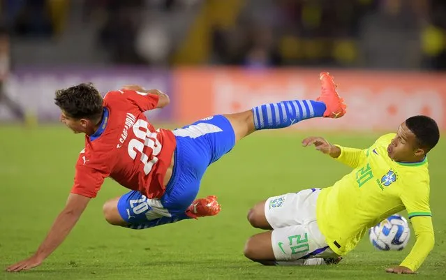 Paraguay's Tobias Sanabria (L) vies for the ball with Brazil’s Pedro Henrique during the South American U-20 championship football match at El Campin stadium in Bogota, Colombia on February 6, 2023. (Photo by Daniel Munoz/AFP Photo)