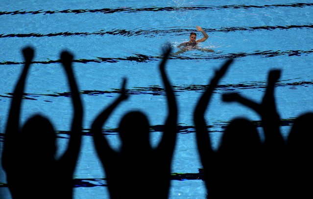 Spanish team memebers cheer as Spain's Iris Tio Casas performs during the women solo technical finalduring the Singapore 2025 World Aquatics Championships at World Aquatics Championships Arena on July 19, 2025 in Singapore. (Photo by Maye-E Wong/Reuters)