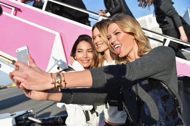 (L-R) Victoria's Secret Model Lily Aldridge, Behati Prinsloo and Karlie Kloss take a picture before they depart for London for the 2014 Victoria's Secret Fashion Show at JFK Airport on November 30, 2014 in New York City. (Photo by Mike Coppola/Getty Images for Victoria's Secret)