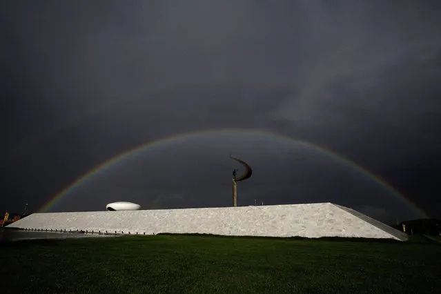 Rainbow is seen over the JK Memorial in Brasilia, Brazil, Monday, November 17, 2014. The JK Memorial was designed by architect Oscar Niemeyer, inaugurated on September 12, 1981 and is dedicated to former Brazilian President Juscelino Kubitschek, founder of Brasilia. (Photo by Eraldo Peres/AP Photo)