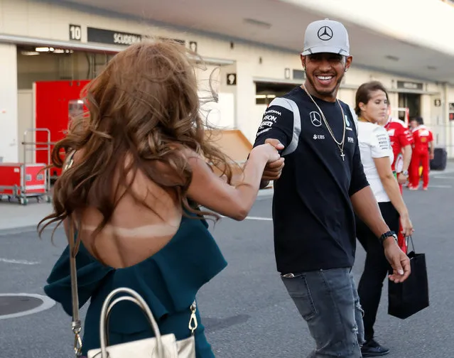Formula One, Japanese Grand Prix, Suzuka Circuit, Japan on October 6, 2016. Mercedes' Lewis Hamilton of Britain shakes hands with a fan at the paddock. (Photo by Toru Hanai/Reuters)