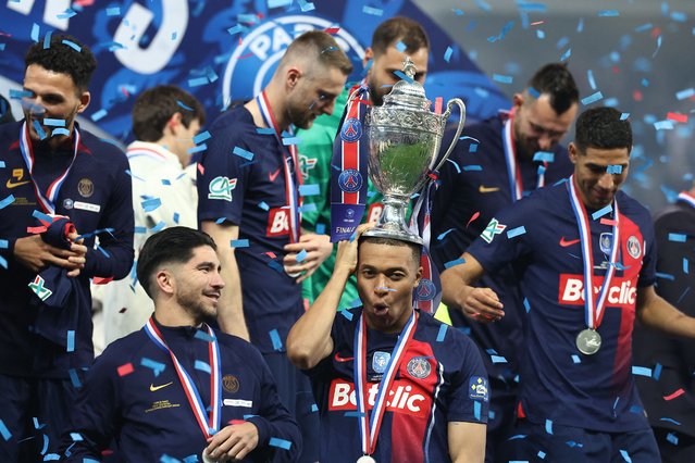 Paris Saint-Germain's French forward #07 Kylian Mbappe (2R) celebrates with the trophy after winning the French Cup Final football match between Olympique Lyonnais (OL) and Paris Saint-Germain (PSG) at the Stade Pierre-Mauroy, in Villeneuve-d'Ascq, northern France on May 25, 2024. (Photo by Franck Fife/AFP Photo)