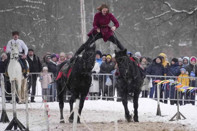 Riders show off their skills during the Maslenitsa (Shrovetide) holiday celebrations in St. Petersburg, Russia, Sunday, February 26, 2023. (Photo by Dmitri Lovetsky/AP Photo)