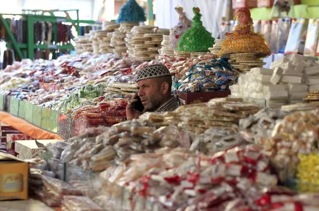 A man sells traditional sweets for children to celebrate the birthday of prophet Muhammad, also known as “mawlid al nabi”, which will fall next week, in a makeshift tent in Cairo, December 30, 2014. (Photo by Mohamed Abd El Ghany/Reuters)
