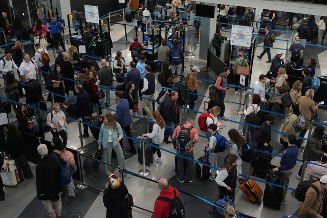 Travelers wait at a security checkpoint at O'Hare International Airport in Chicago on Friday, November 7, 2025. More than 1,000 flights were canceled on the first day of the Trump administration’s mandatory cuts to reduce US air traffic. (Photo by Nam Y. Huh/AP Photo)