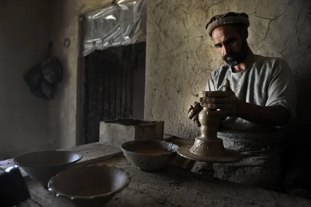 An Afghan produces pottery at a shop in the Istalif district of Kabul, Afghanistan, 16 September 2015. The small village of Istalif is famed for its pottery and use to be frequented by many foreigners to buy the wares however workers are concerned with the declining number of foreigners in the country due to the ongoing security situation. (Photo by Jawad Jalali/EPA)