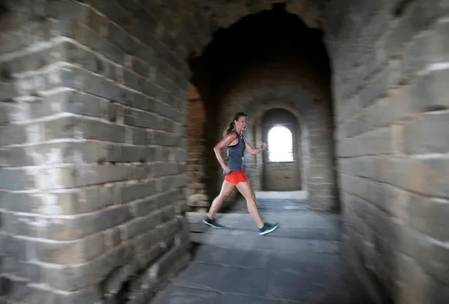 A participant runs through a tower during the Great Wall Marathon at the Huangyaguan section of the Great Wall of China, in Jixian of Tianjin, China May 19, 2018. (Photo by Jason Lee/Reuters)