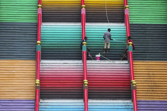 Workers clean the 272 steps at the major Hindu temple and tourist attraction Batu Caves Temple in Kuala Lumpur, Malaysia, 06 January 2021. “The government is considering opening its border to help boost the tourism sector, we are now working at negotiating with countries such as Singapore, Brunei, Korea, Japan, Taiwan and New Zealand which have been identified as Green Zones”, Tourism, Arts and Culture Minister Nancy Shukri said on 27 December 2020. (Photo by Fazry Ismail/EPA/EFE)