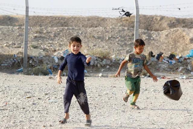 Children who fled the Islamic State's strongholds of Hawija and Mosul, play at a camp for displaced people in Daquq, Iraq, October 13, 2016. (Photo by Ako Rasheed/Reuters)