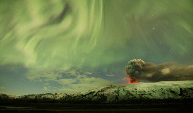 The Northern Lights are seen above the ash plume of Iceland's Eyjafjallajokull volcano, on April 22, 2010. (Photo by Lucas Jackson/Reuters)