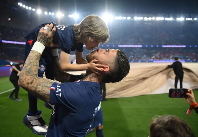 Paris Saint-Germain's Spanish defender Sergio Ramos kisses his child during the 2022-2023 Ligue 1 championship trophy ceremony following the L1 football match between Paris Saint-Germain (PSG) and Clermont Foot 63 at the Parc des Princes Stadium in Paris on June 3, 2023. (Photo by Franck Fife/Pool via AFP Photo)