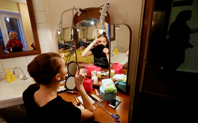 A contestant Anna Salenkova of Russia prepares backstage before performing at the “Grand Prix of Siberia” international ballet competition, held as part of the 4th International Forum “Ballet. XXI Century”, at the State Opera and Ballet Theatre in Krasnoyarsk, Siberia, Russia, November 11, 2016. (Photo by Ilya Naymushin/Reuters)